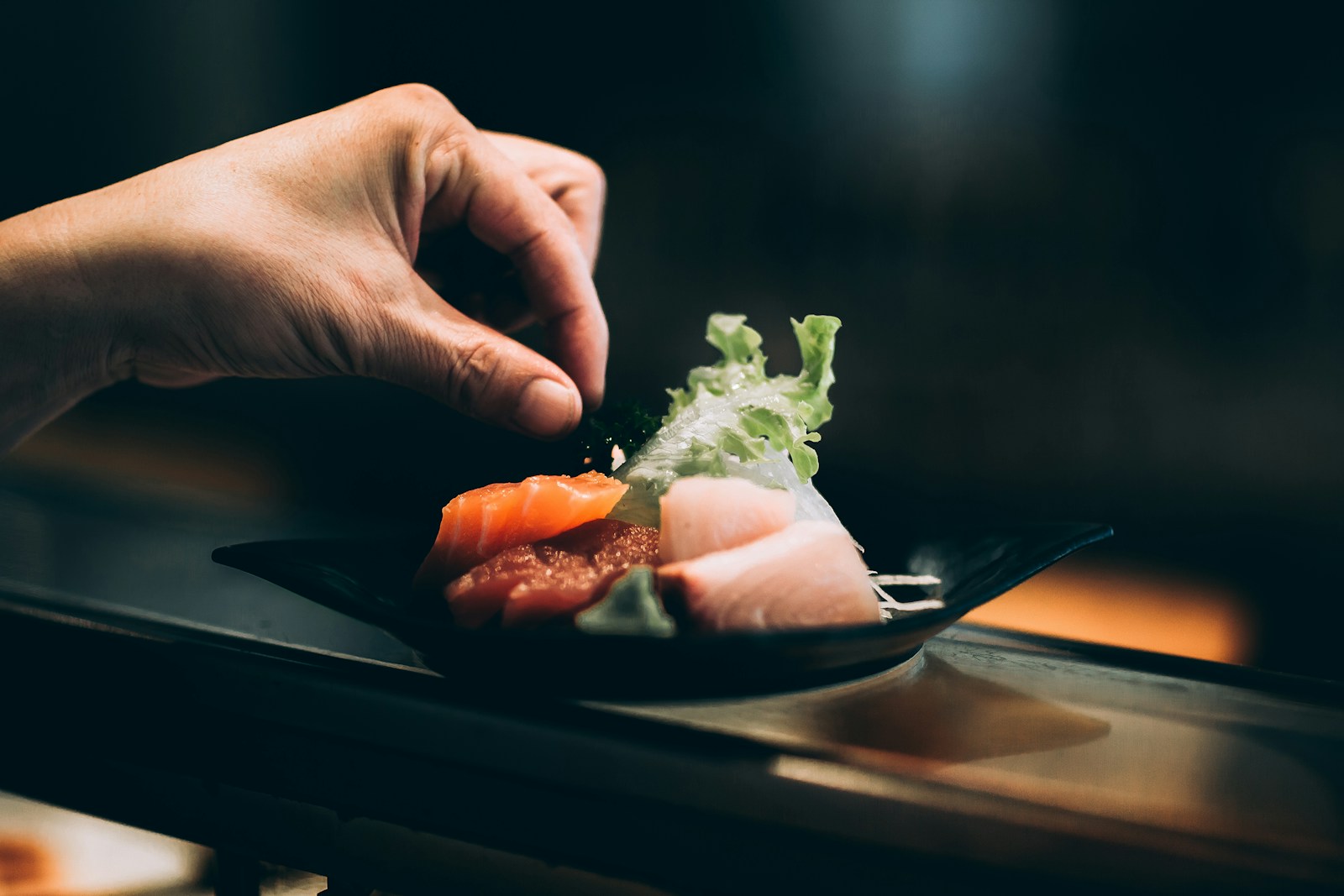 Photo by Kyle Head left hand picking vegetable on plate